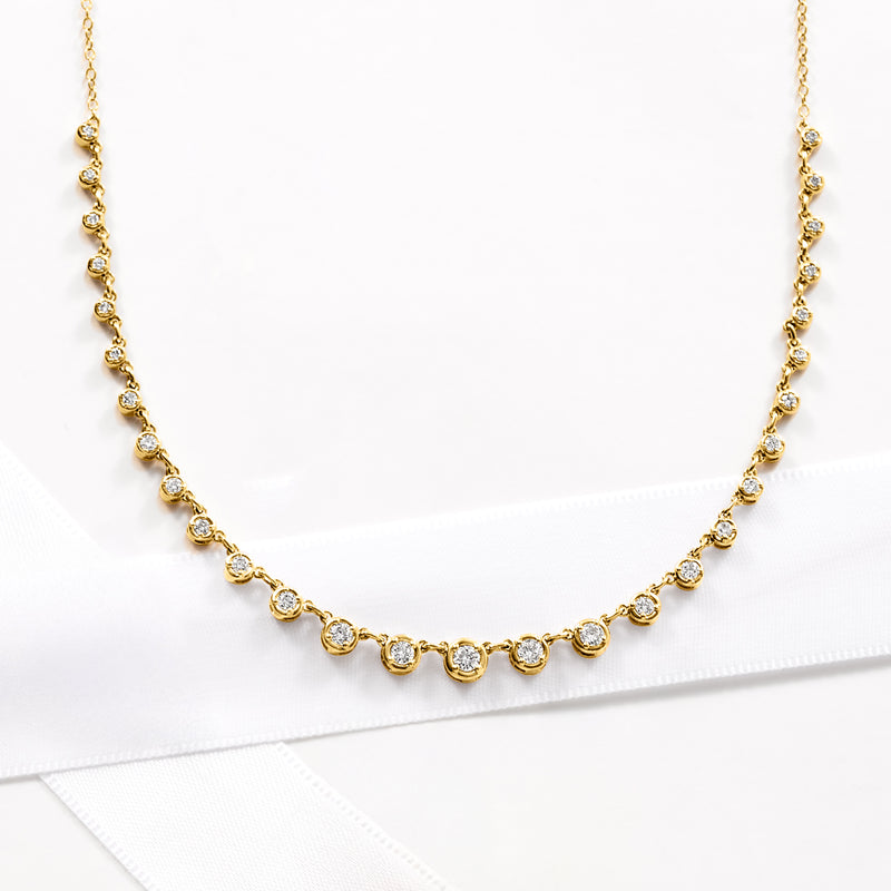 Graduated bezel-set diamond necklace with round stones, 18kt gold over sterling