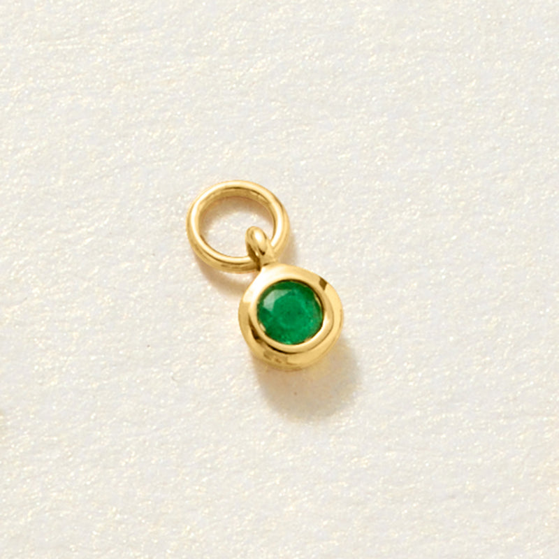 14kt yellow gold hoop charm with green bezel-set emerald stone