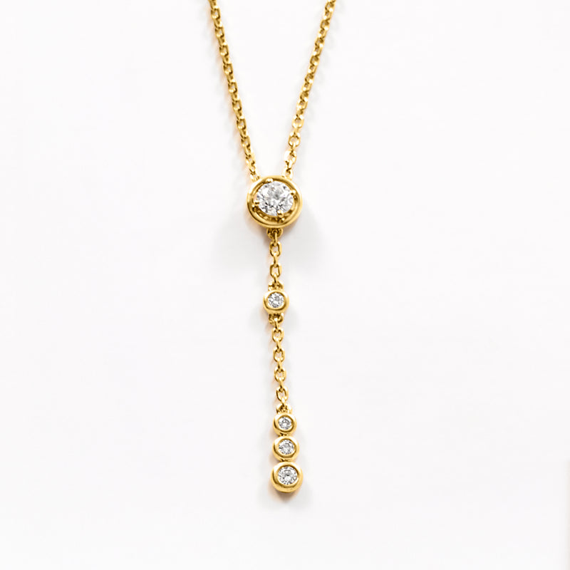 Gold Y-necklace pendant with round bezel-set diamonds in a vertical row