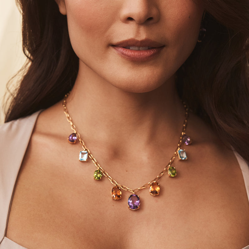Gold over sterling multi-gemstone drop necklace close-up with purple center and colored drops
