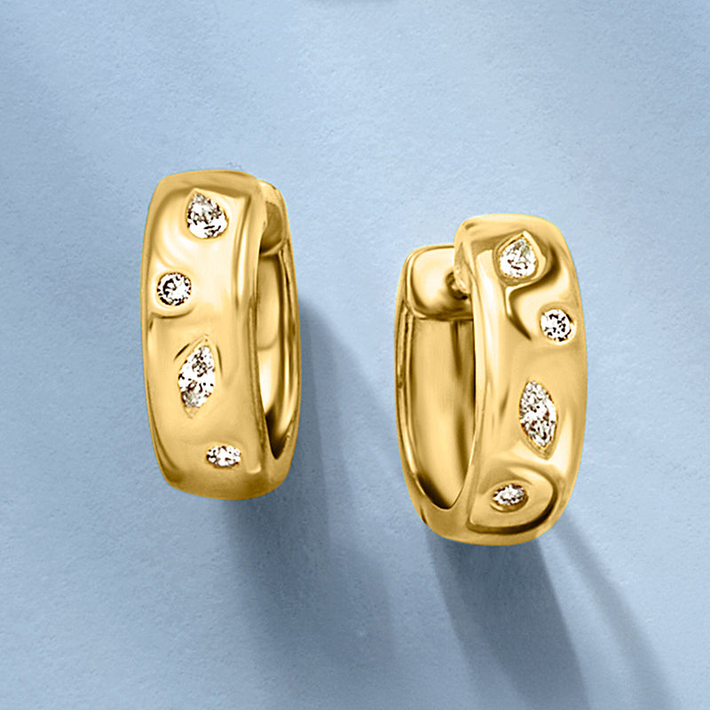 Gold hoop earrings with three round diamond highlights on bezel face