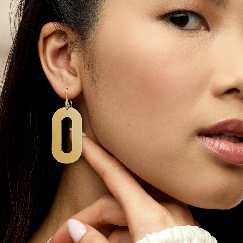 Gold over sterling oval drop earrings worn with earwire, long open center