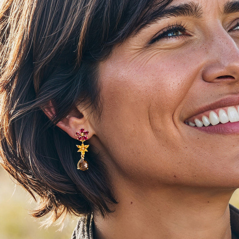 Gold-tone flower drop earrings with pink centers and smoky teardrop dangles