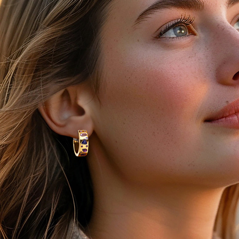 Purple gemstone hoop earrings on model, gold-tone band with small oval stones