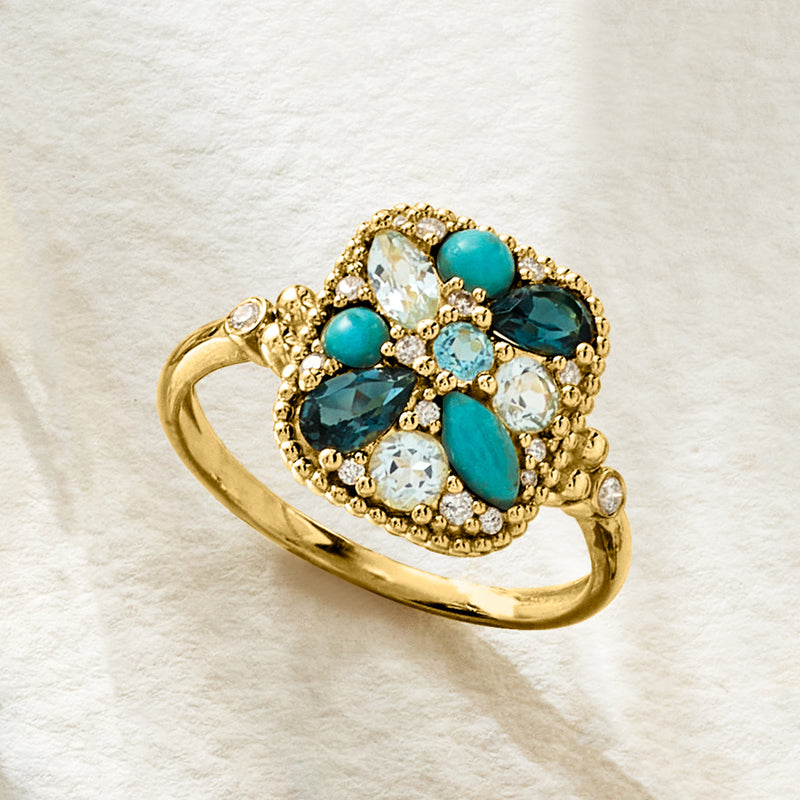 Gold multi-gem ring with turquoise and light-blue teardrop stones, surrounded by clear accents