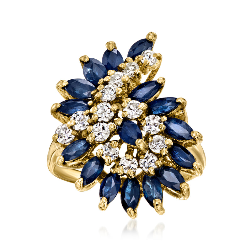 14kt yellow gold swirl ring with blue sapphire and diamond cluster petals