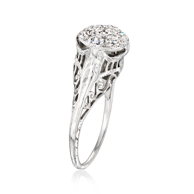 White gold ring with oval diamond cluster and openwork filigree sides