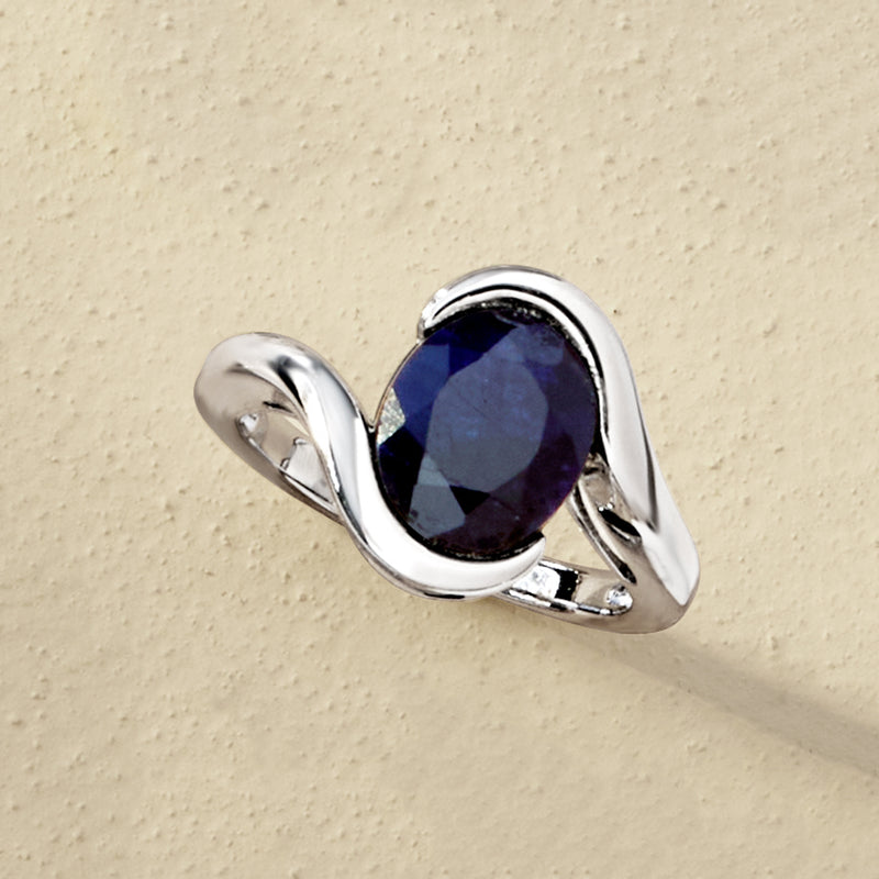 Sterling silver ring with deep blue oval sapphire and curved claw-like prongs