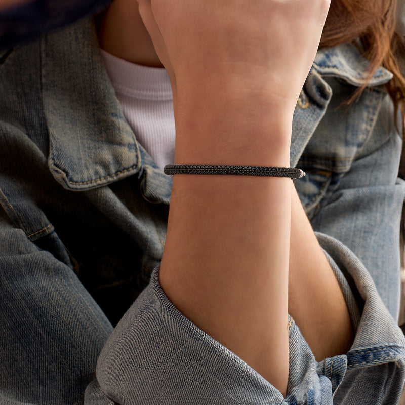 Black spinel bangle bracelet on wrist with slim sterling silver frame