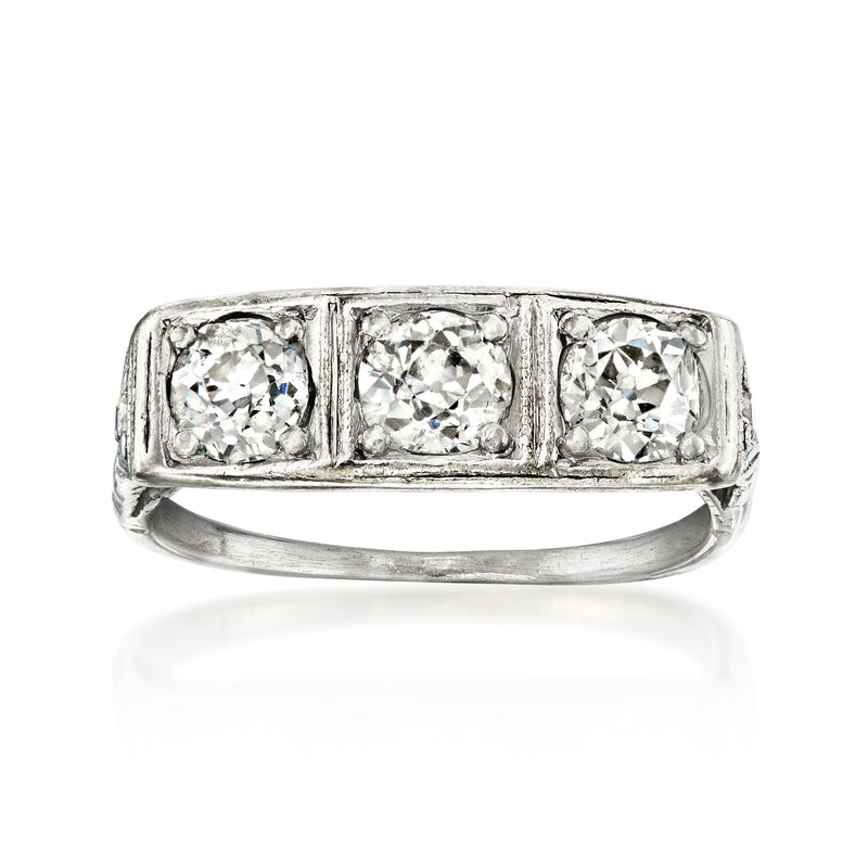 Vintage three-stone diamond ring in platinum with three round stones and squared settings