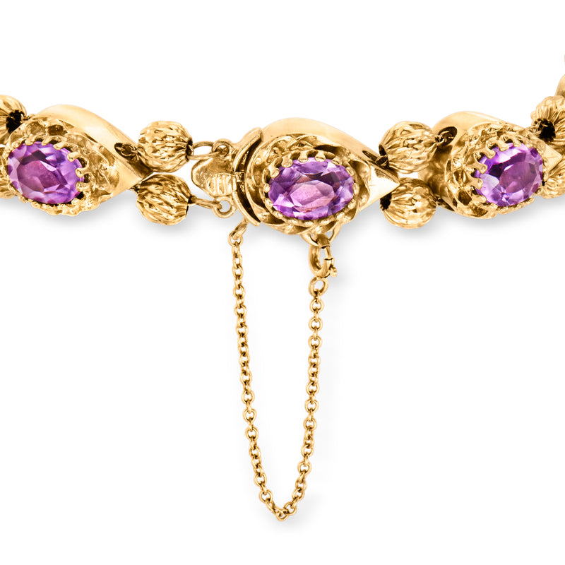 Yellow gold amethyst slide bracelet with round purple stones and drop chain detail