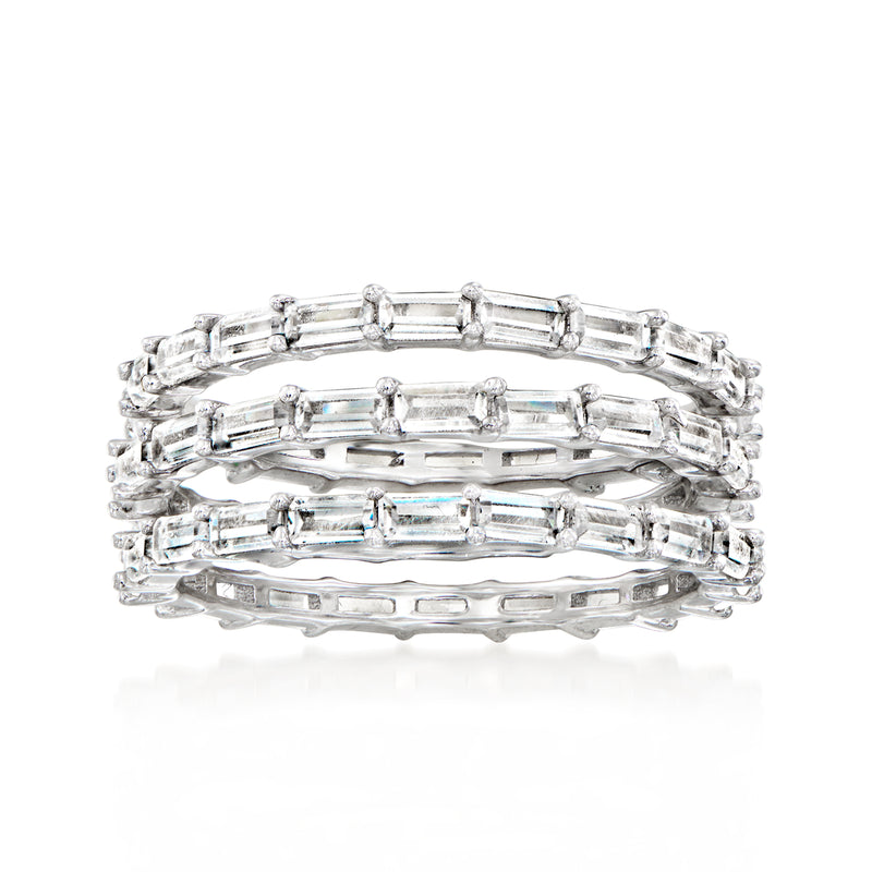 Three stacked sterling-silver CZ rings with baguette-style stones, polished band