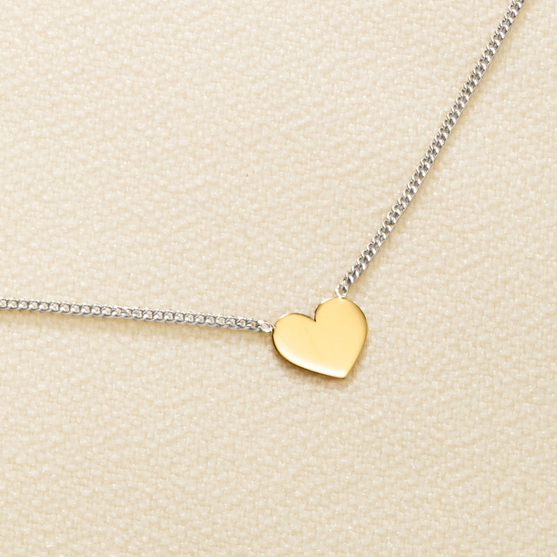 Yellow gold heart pendant on sterling silver curb-link chain