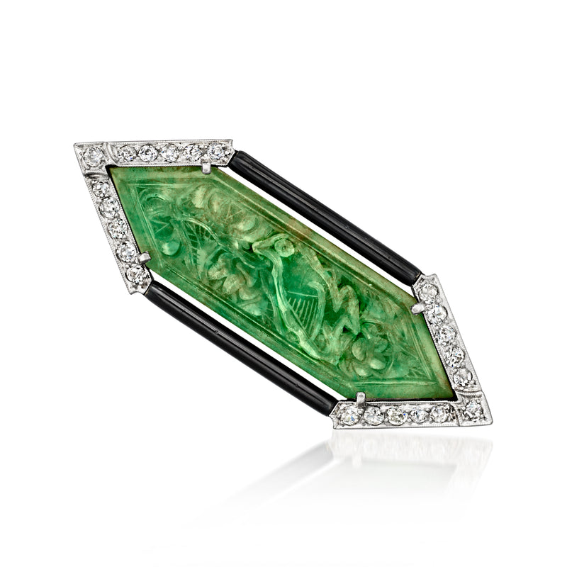 Jade bird pin with carved green jade, black enamel borders, and diamond accents in white metal