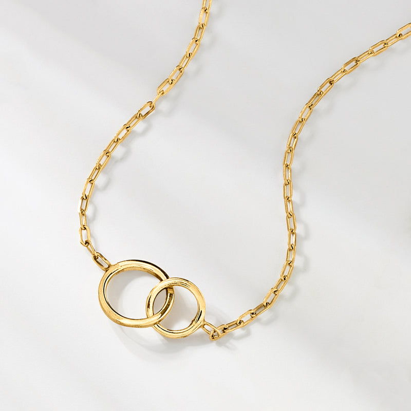 Gold double-circle necklace with interlocking rings and curb link chain