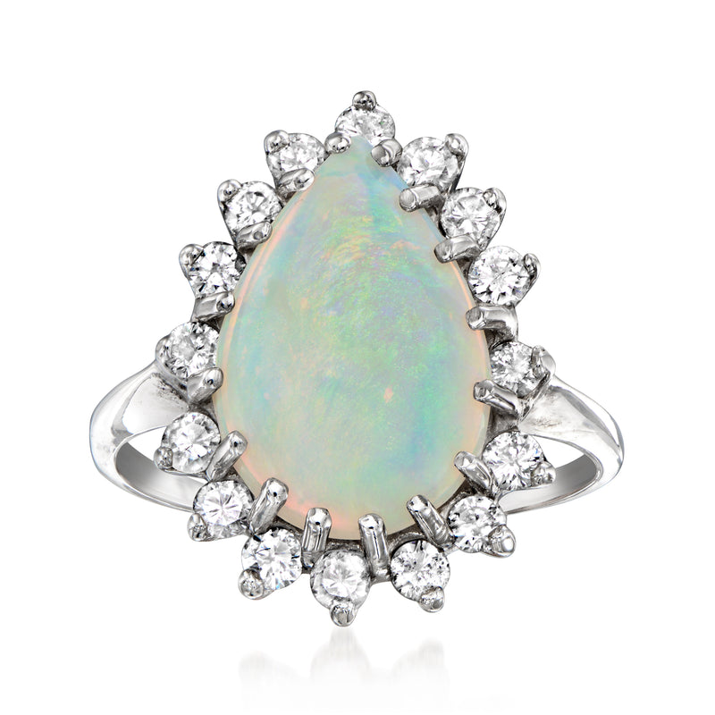 14kt white gold ring with oval opal center and round diamond halo