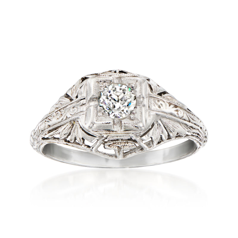 Vintage platinum diamond ring with round center stone and engraved scrollwork band