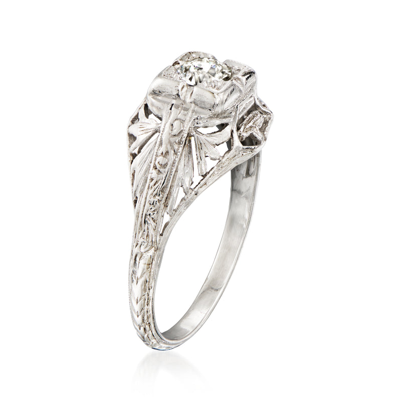 Platinum vintage diamond ring with round center stone in ornate pronged setting, side view