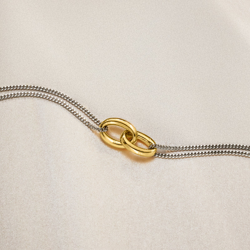 Interlocking oval bracelet close-up with gold oval links on silver chain