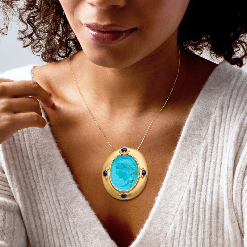 Turquoise oval pendant on thin gold chain with blue lapis side accents