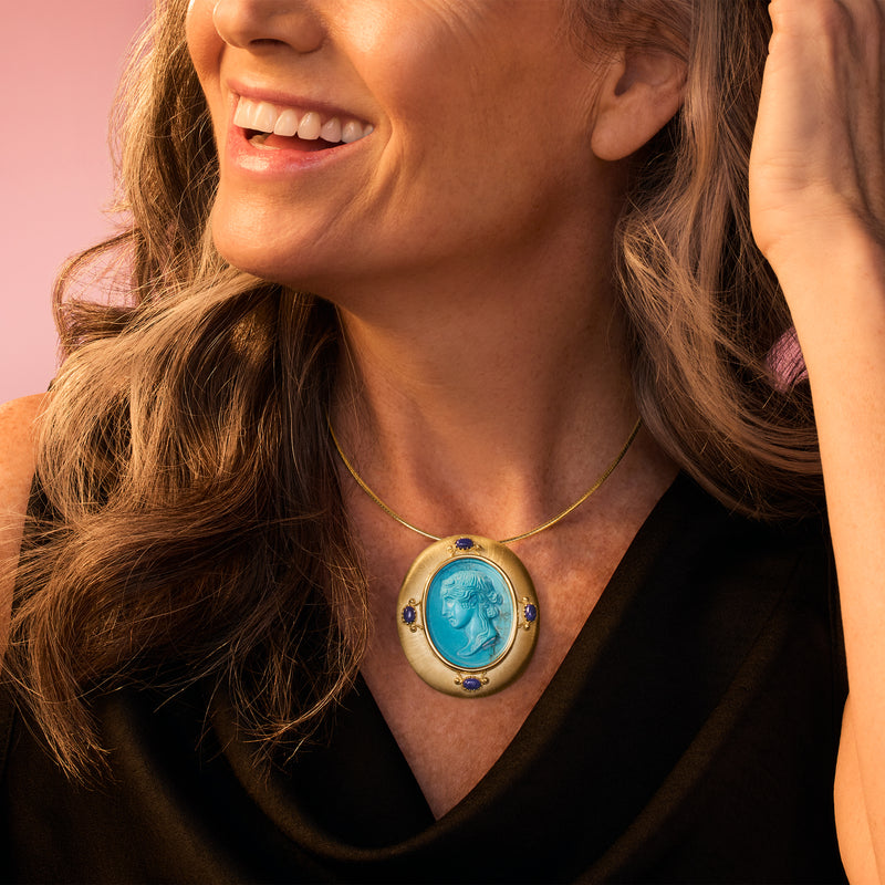 Large oval turquoise pendant necklace with gold frame and blue lapis details
