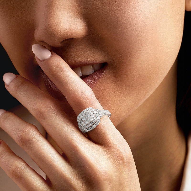 Vintage diamond cluster ring in white gold on a finger