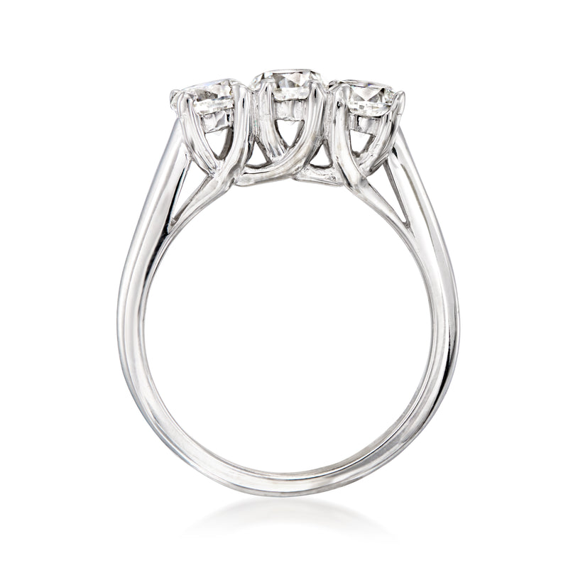 Three-stone diamond ring top view with white gold prong settings and central stone