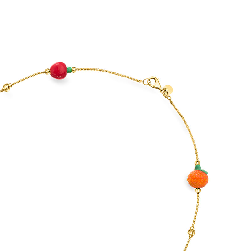 Gold-tone necklace clasp with red bead and orange fruit charm on the chain