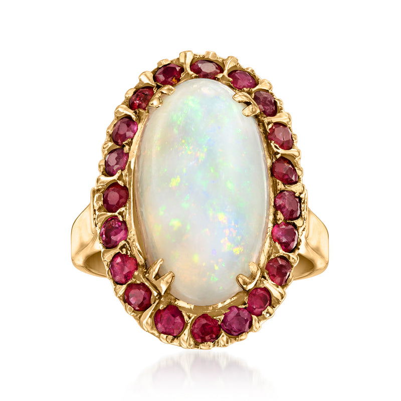 Vintage oval opal ring in 14kt yellow gold with red ruby halo and prong setting