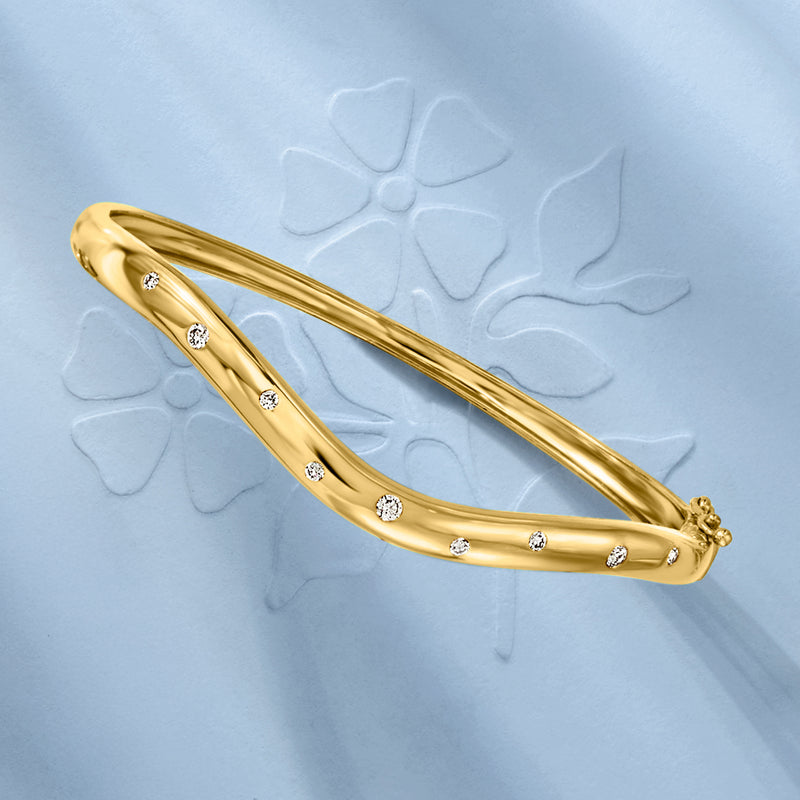 Curved gold bangle bracelet with row of round diamonds, side view and end detail