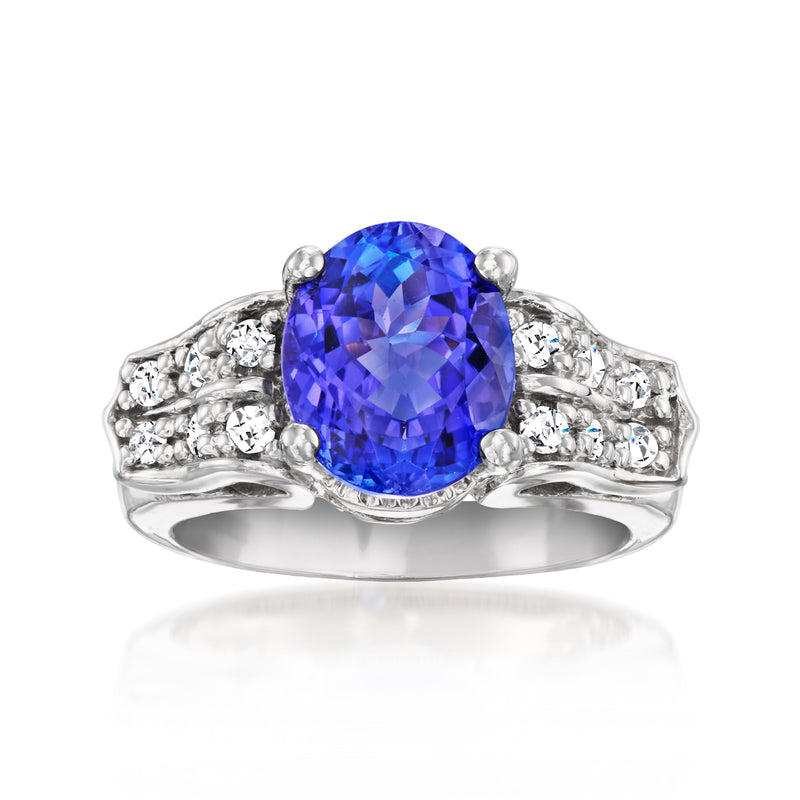Vintage white gold tanzanite ring with oval blue gemstone and diamond side accents