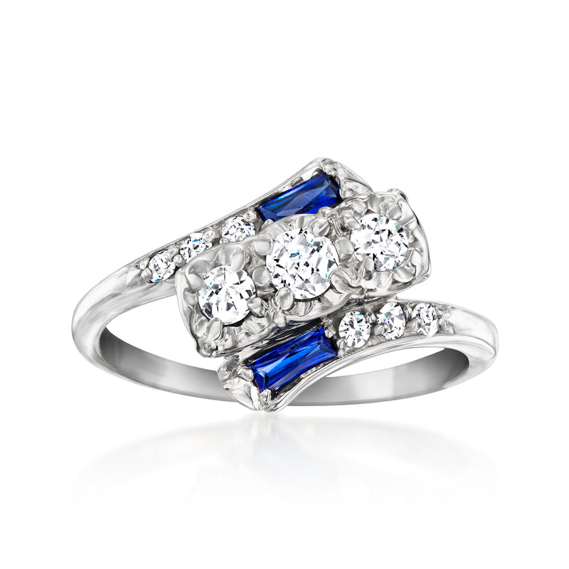 Vintage white gold ring with blue sapphire and diamond-like stones, oval cluster setting