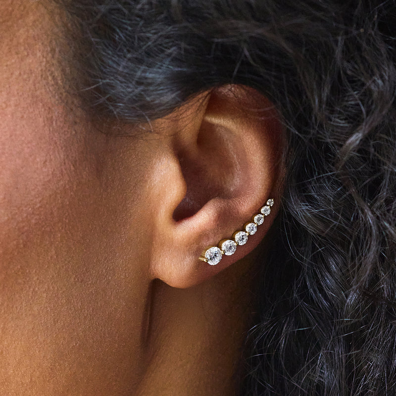 14kt yellow gold diamond ear climber earrings with oval stones, close-up ear