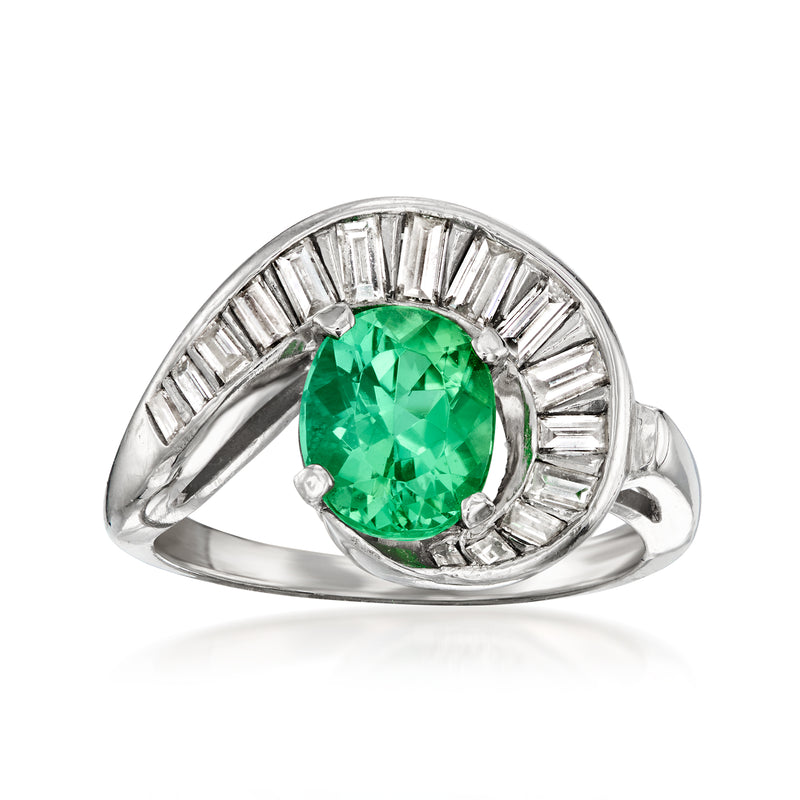 Platinum swirl ring with oval green tourmaline center and baguette diamond band