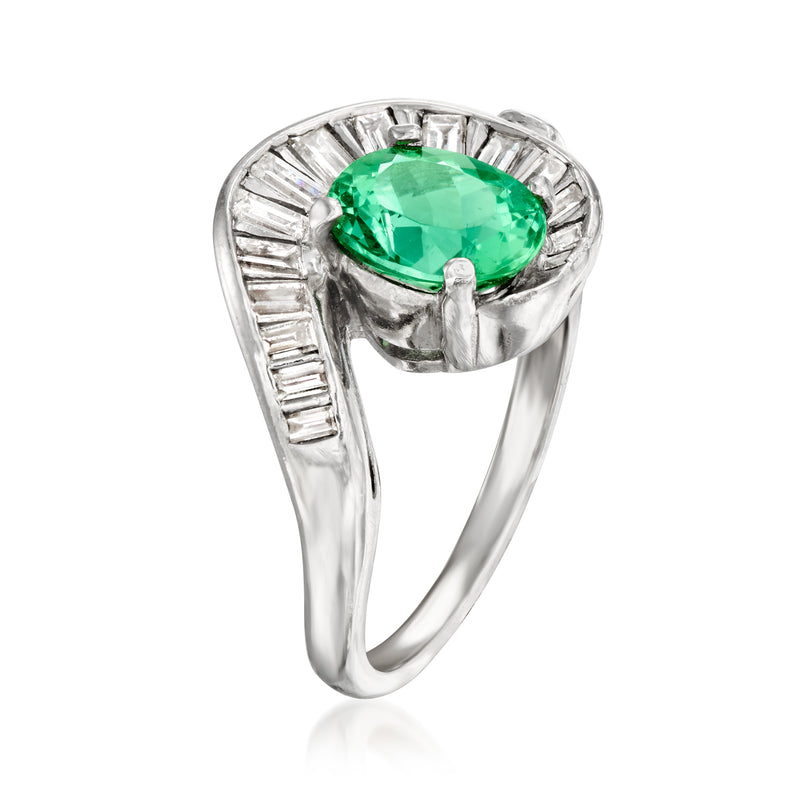 Platinum ring featuring oval green tourmaline set in diamond-lined swirl mounting