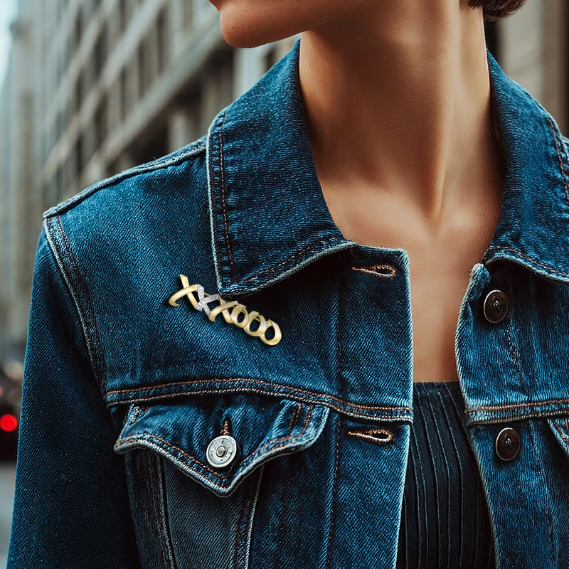 XO diamond pin on denim jacket collar, gold with platinum accents