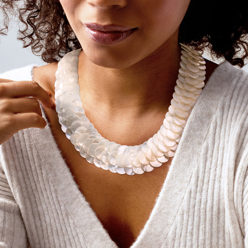 Multi-row mother-of-pearl disc necklace, close-up on white iridescent shell discs