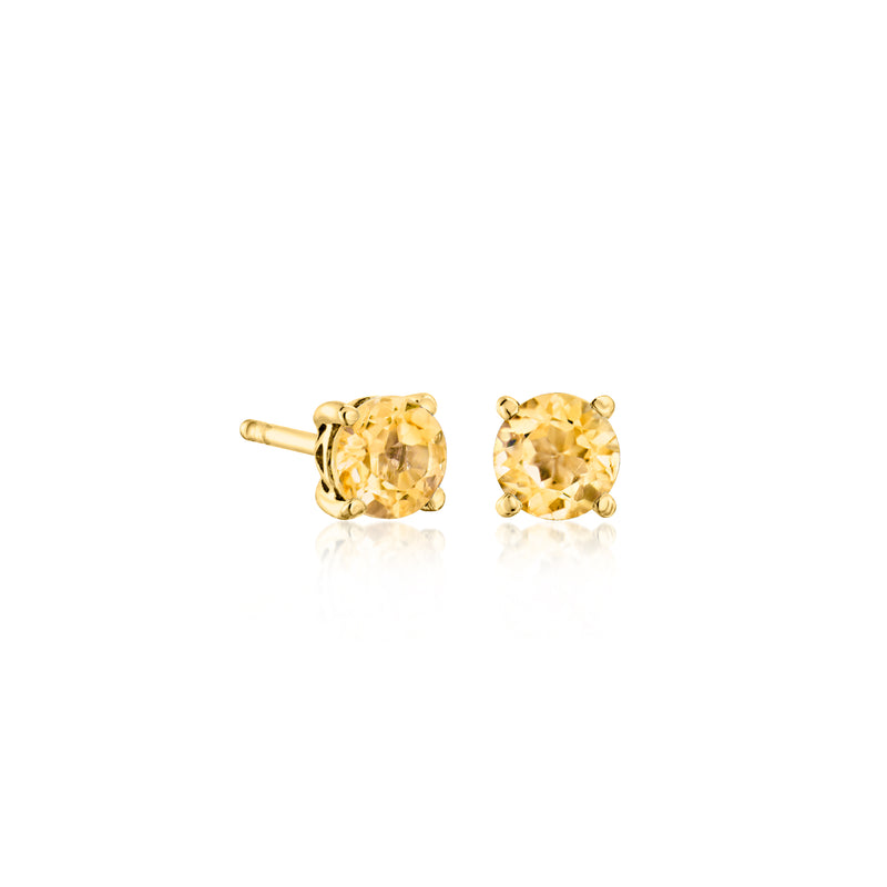 Gold-tone round gemstone stud earrings pair with citrine-yellow stones and prong settings