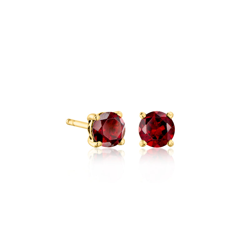 Gold-tone round gemstone stud earrings pair with deep red stones and prong settings