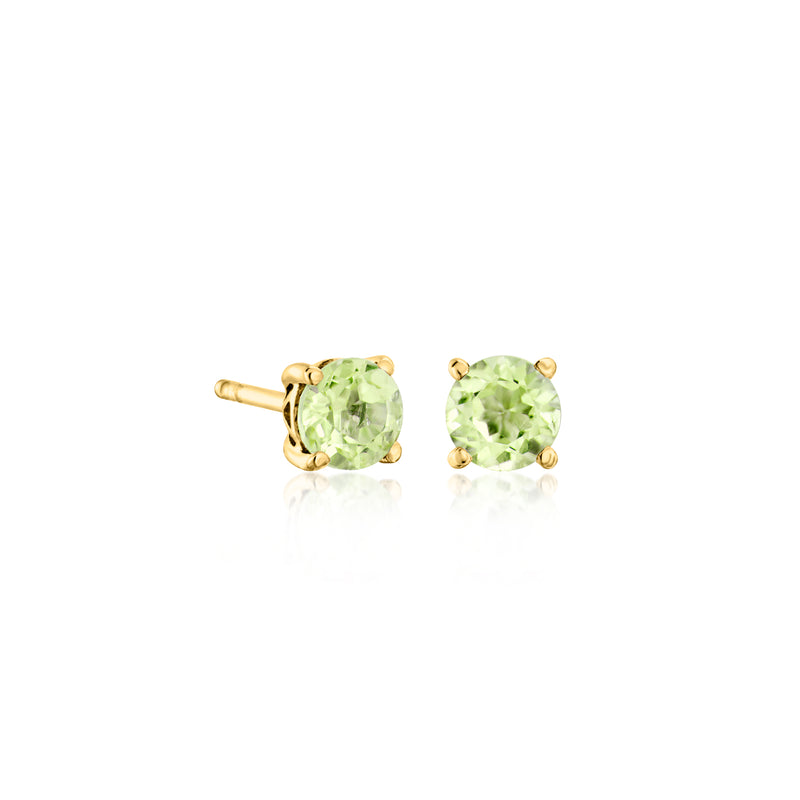 Gold-tone round gemstone stud earrings pair with light green stones and prong settings