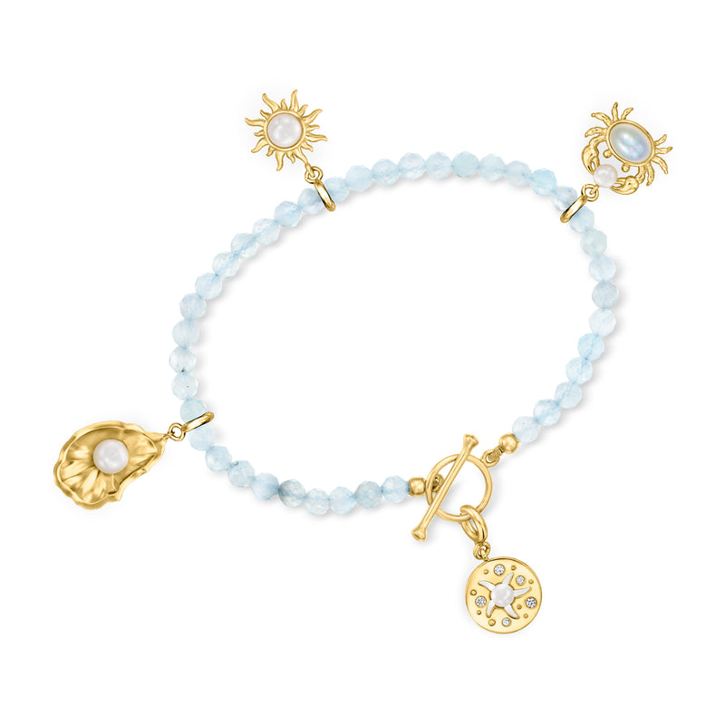 Aquamarine bead bracelet with gold toggle and celestial charms: sun, moon, disc