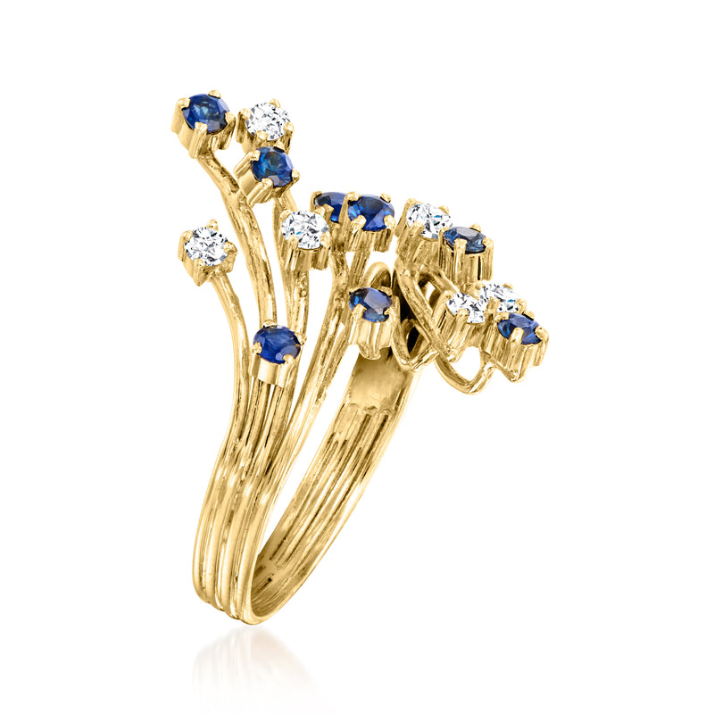 14kt yellow gold bypass ring side view with blue sapphires and diamond clusters