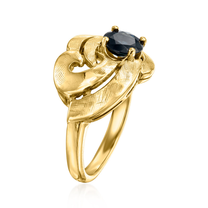 Swirl ring with dark blue oval gemstone in 14kt yellow gold, open band