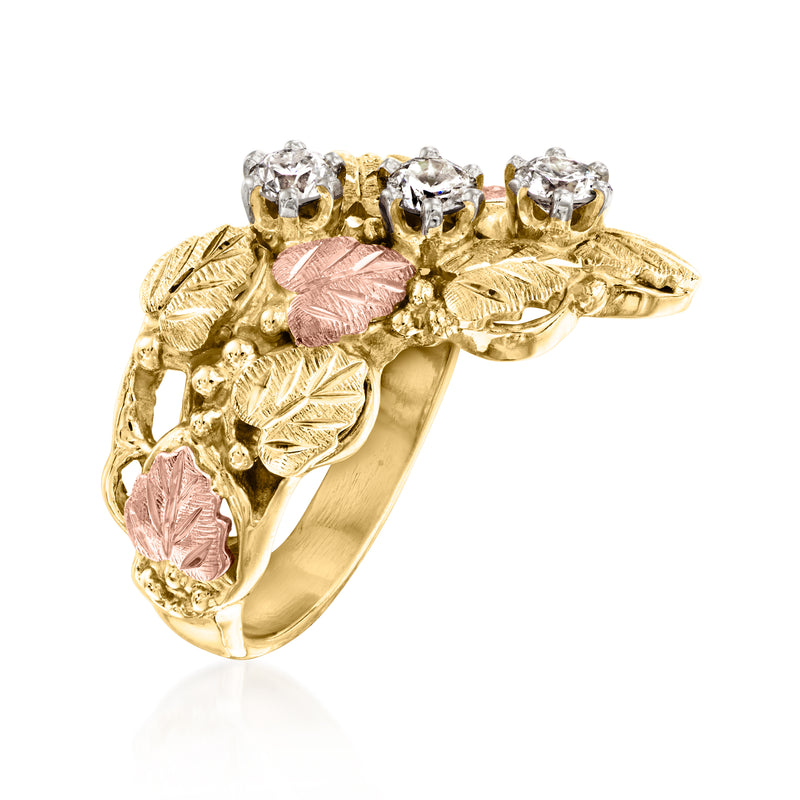 Side view of two-tone gold leaf ring with round clear stones and pink centers