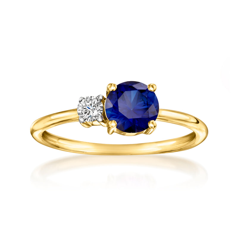 Gold ring with oval blue sapphire center and round diamond accent, high-set bezel