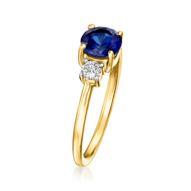 Gold ring with raised oval blue sapphire and round diamond on the front