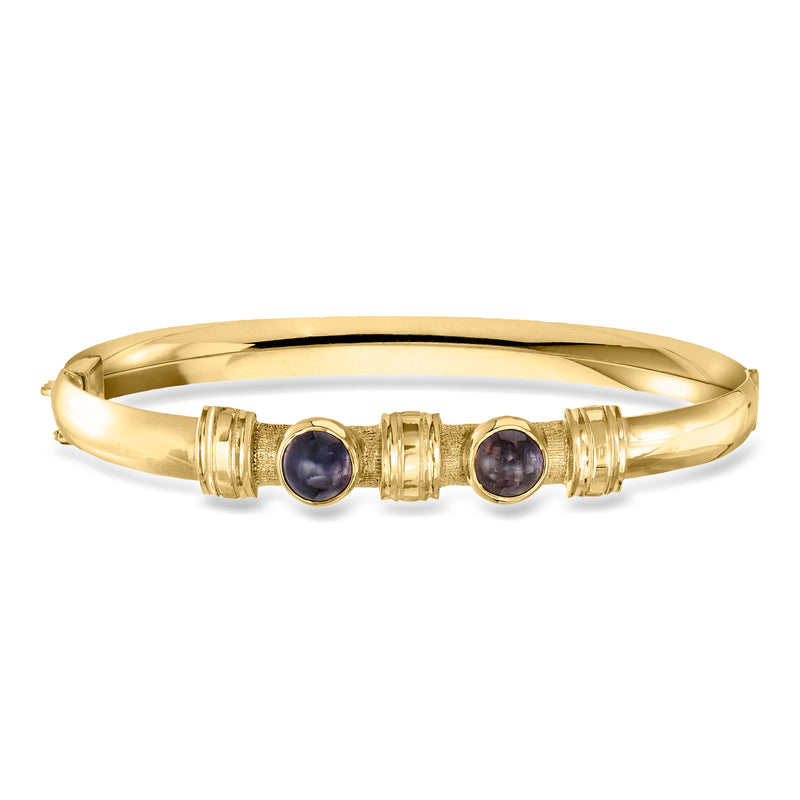 18k yellow gold bangle with two round dark amethyst cabochons and textured settings