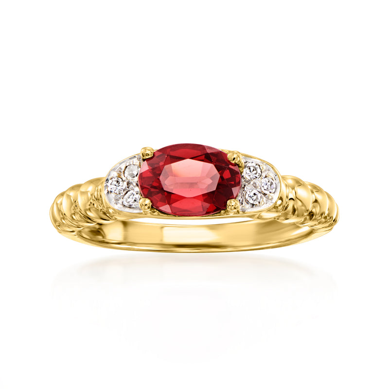 Vintage garnet and diamond ring in 14kt yellow gold, red oval center with diamond halo