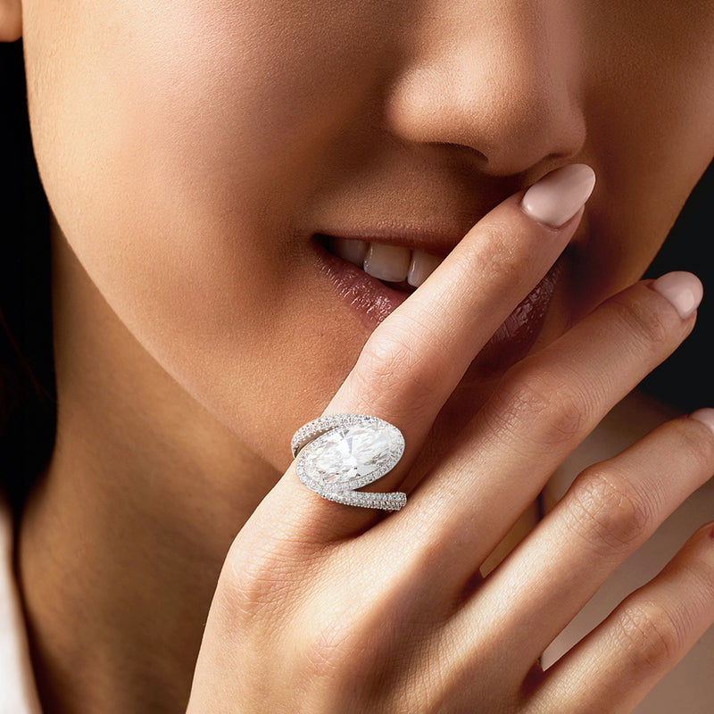 Oval lab-grown diamond asymmetrical platinum ring on a model's finger