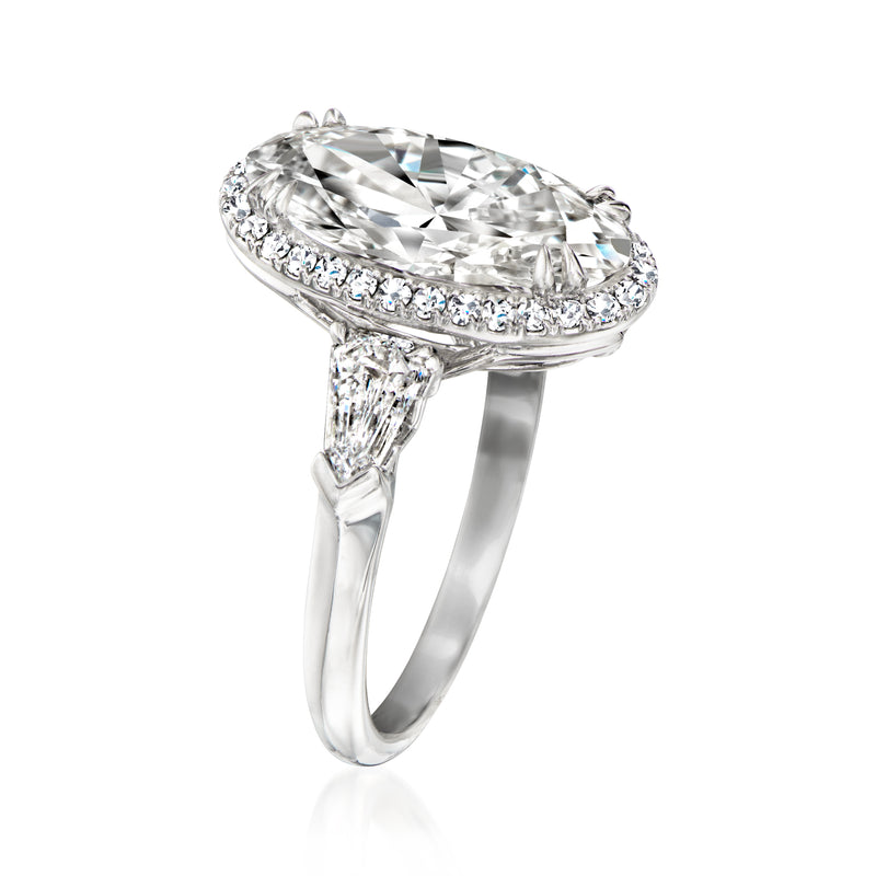 Platinum lab-grown diamond ring with oval halo and pronged setting, angled view